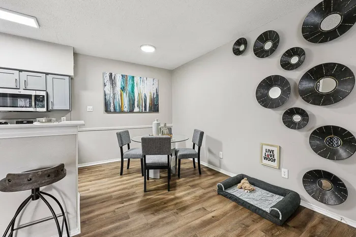 Modern dining room with natural light at Collin Creek Apartments in Plano, TX