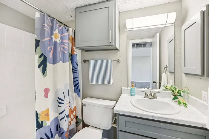 Spacious bathroom in Collin Creek Apartments Plano TX with elegant cabinetry and large mirror