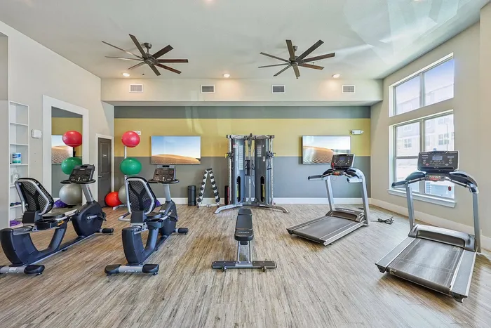 Modern fitness center with cardio and strength equipment at McDermott 55 Plano