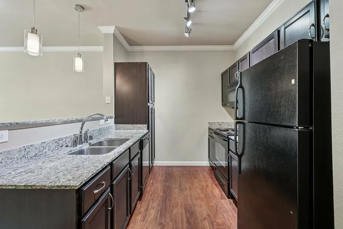 Open-concept kitchen with modern finishes at McDermott 55 Plano, TX