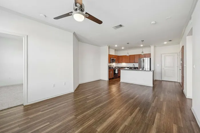 Spacious open kitchen and living area with island at McDermott 55 Plano