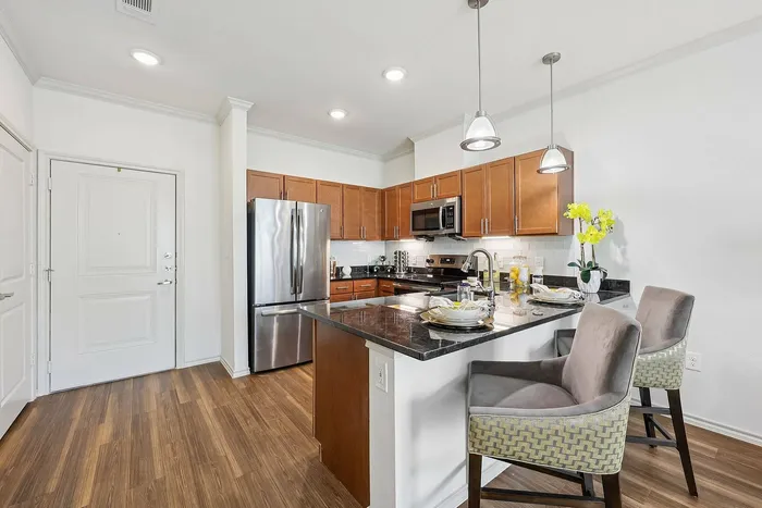 Elegant kitchen with large island at McDermott 55 apartments in Plano