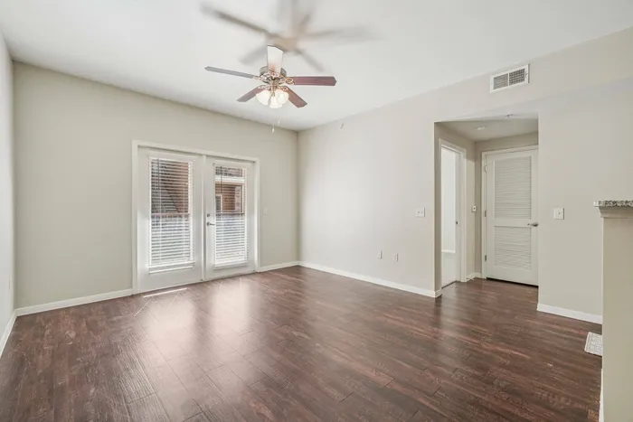Open living area leading to outdoor patio at Walnut Grove Seguin apartments