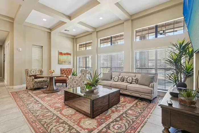 Spacious indoor sitting area with stylish furniture and natural light at Walnut Grove apartments in Seguin, TX