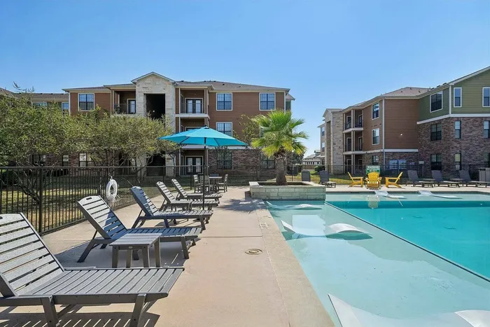 Luxury apartment pool with sundeck and beach entry at Walnut Grove Seguin