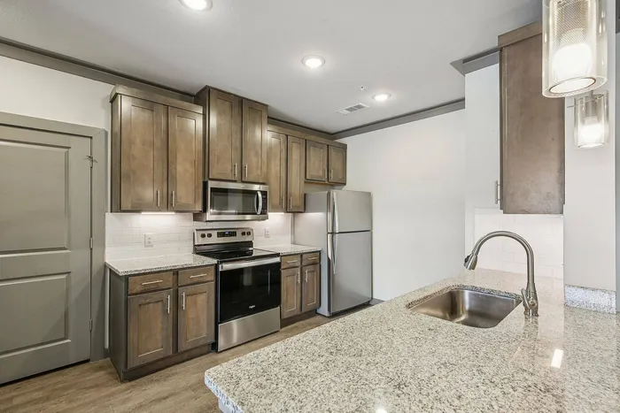 Spacious apartment kitchen with granite countertops at Cityscape Apartments Houston