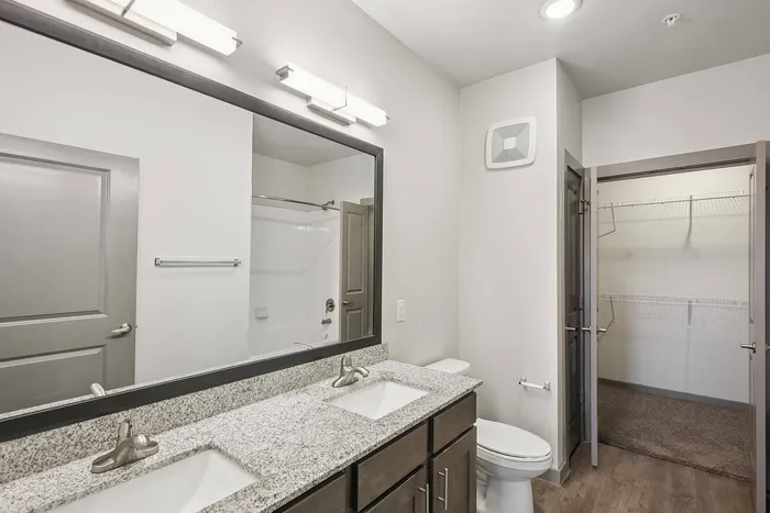 Modern bathroom with walk-in closet at Cityscape Apartments in Houston, TX
