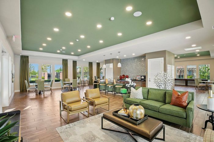 Spacious resident clubhouse with modern seating and coffee bar at Cityscape Apartments in Houston, TX.