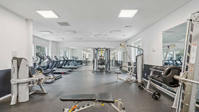 Oak Forest Lewisville modern fitness center with cardio and weight equipment