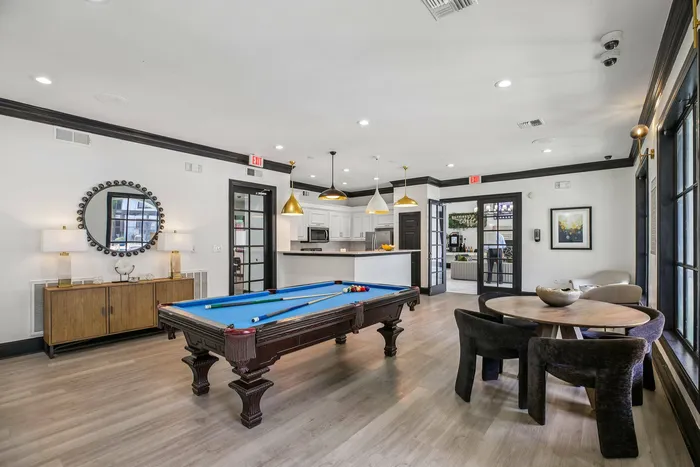 Resident lounge with gaming area and media setup at Providence Uptown Houston