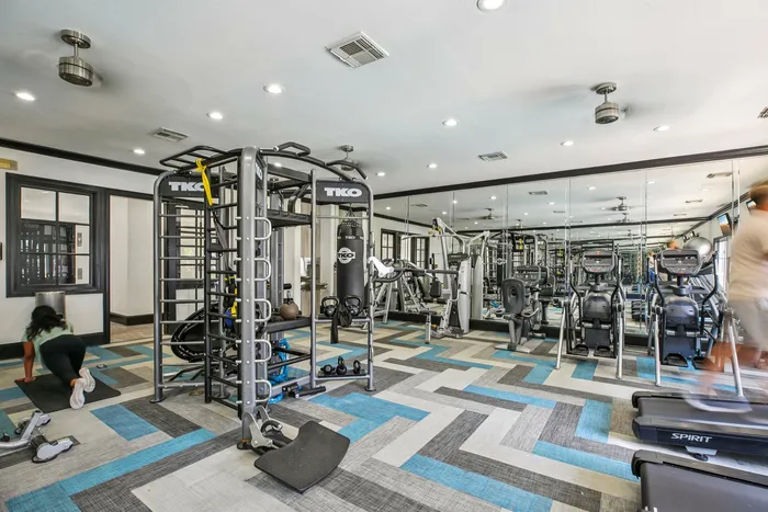 State-of-the-art fitness center at Providence Uptown featuring cardio machines, free weights, and yoga space.
