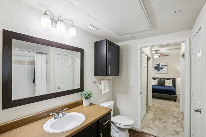 Bright bathroom with subway tile and chrome fixtures at Providence Uptown Houston