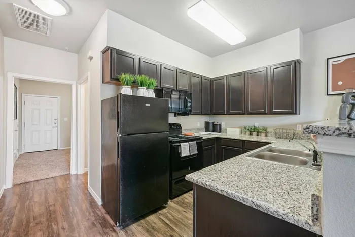 Modern kitchen with stainless steel appliances at Arroyo Seco Villas, San Antonio, TX