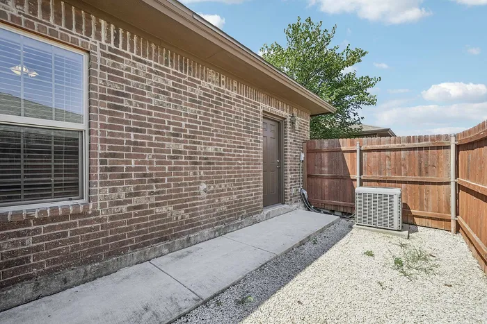 Private backyard with wooden privacy fence at Arroyo Seco Villas, San Antonio, TX