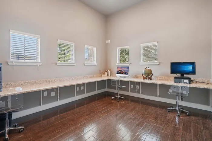 Modern resident business center with computers and workspace at Arroyo Seco Villas in San Antonio, TX