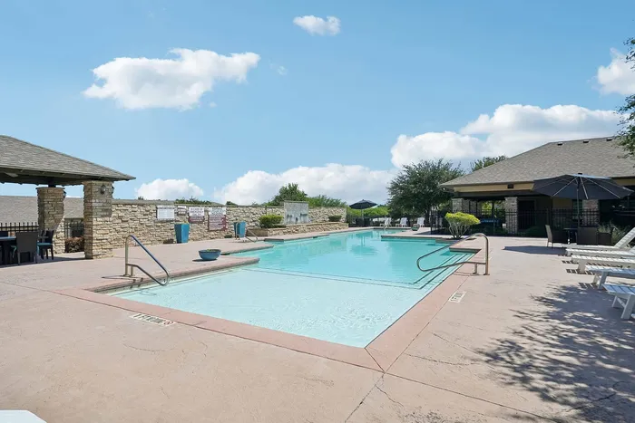 Sparkling pool with lounge chairs at Arroyo Seco Villas in San Antonio