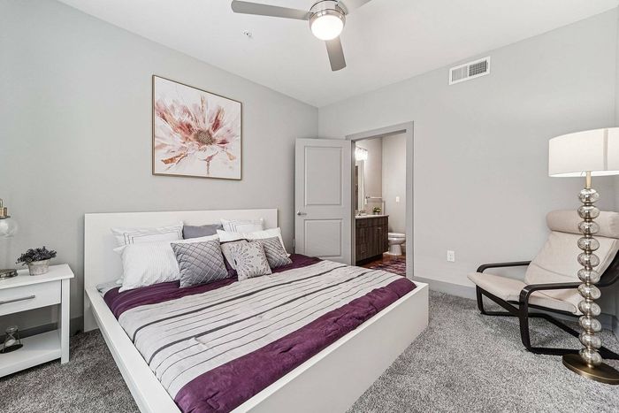 Bright bedroom interior at The Broadway apartments, Houston TX