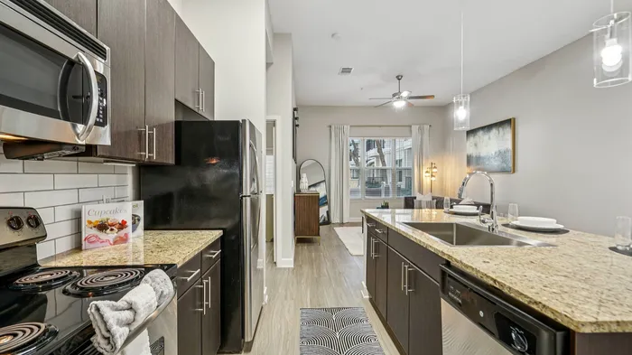Modern kitchen with stainless steel appliances at Addison Keller Springs apartments in Addison, TX