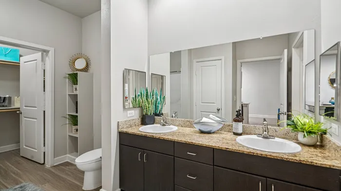 Modern bathroom with dual sinks and walk-in shower at Addison Keller Springs, Addison TX