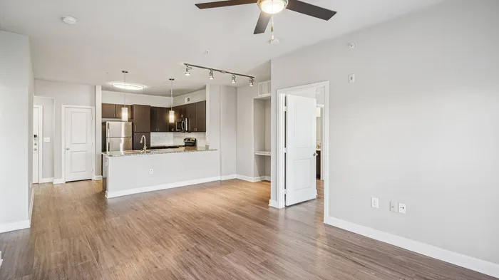 Open-concept kitchen and living area at Addison Keller Springs apartments in Addison, TX