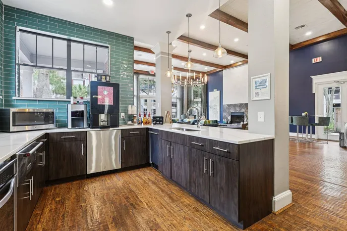 modern kitchen with a coffee maker, seating, and natural lighting