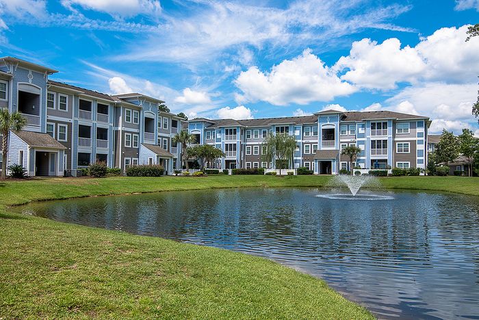 Lake on property with green walking space