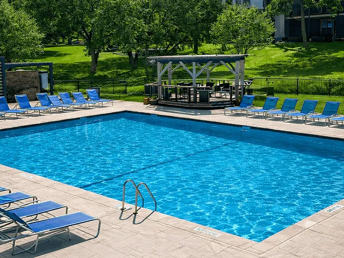 pool with lounge seating and gazebo