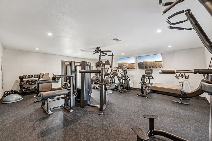Modern leasing office with decor, comfortable seating, and large windows in the Avila apartment community.