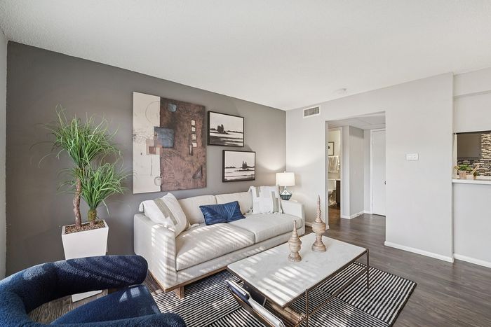 Contemporary living room featuring stylish furniture, a sleek coffee table, and decorative wall art in a Waco, TX apartment.