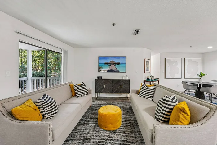 Modern living room with comfortable seating at Avenues of Kennesaw apartments