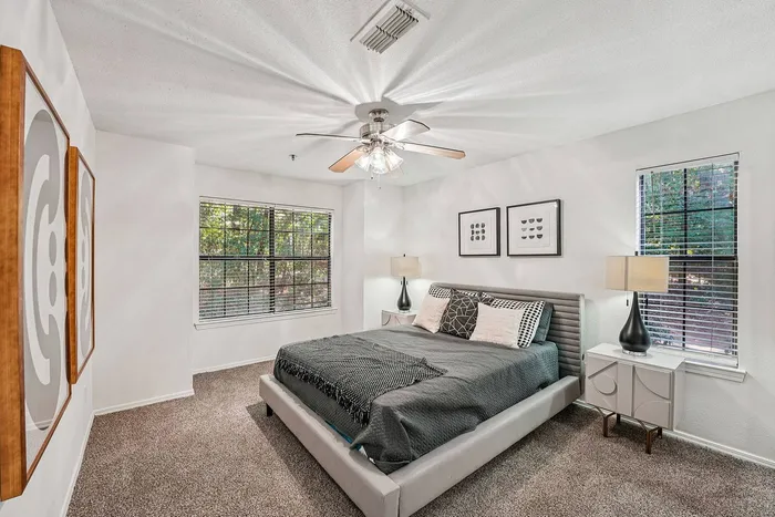 Spacious bedroom with modern furnishings at Avenues of Kennesaw Apartments in Kennesaw, GA