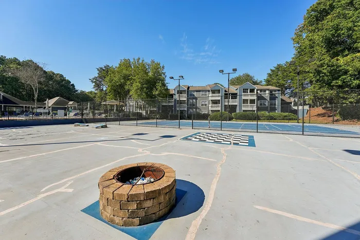 Outdoor multi-sport court with basketball hoops and tennis lines at Avenues of Kennesaw