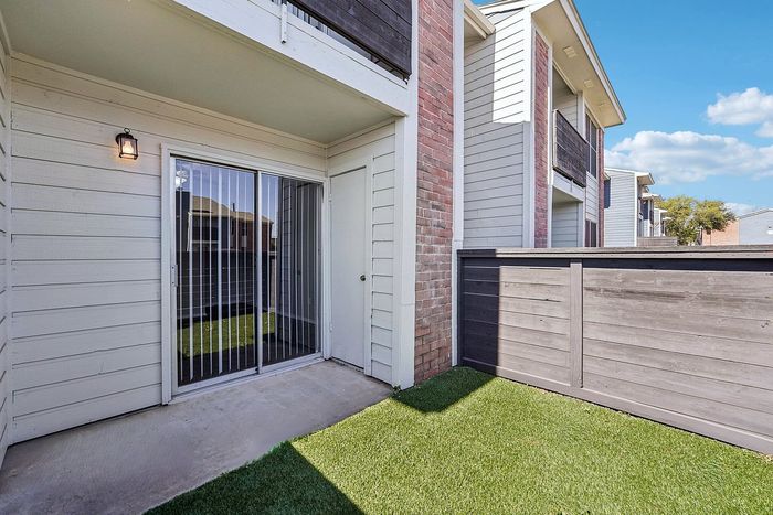 private patio with grass and fence