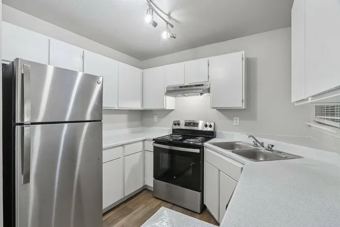Sleek and modern kitchen in Avonmora Apartments, Austin TX with stainless steel appliances and granite countertops.