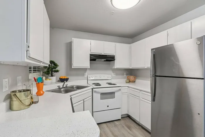 Sleek and modern kitchen in Avonmora Apartments, Austin TX with stainless steel appliances and granite countertops.