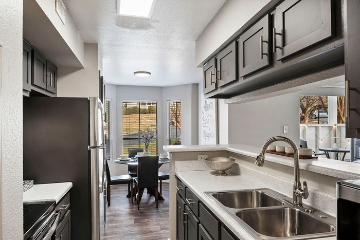 state of the art kitchen with stainless steel and black appliances
