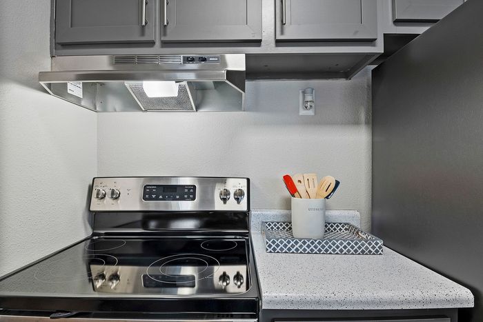 state of the art kitchen with stainless steel and black appliances