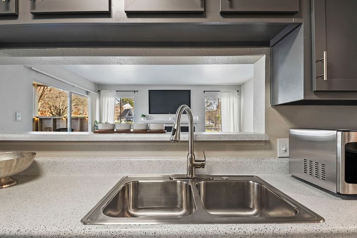 state of the art kitchen with stainless steel and black appliances
