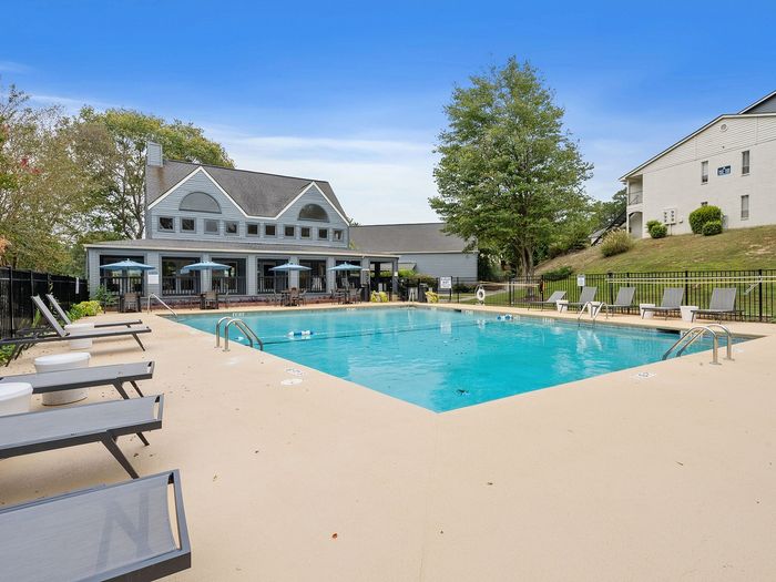 sparkling pool with resort style lounge seating