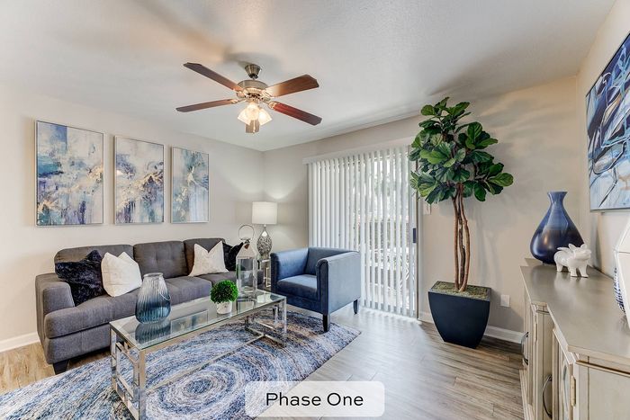 spacious living room with wood style flooring and ceiling fan