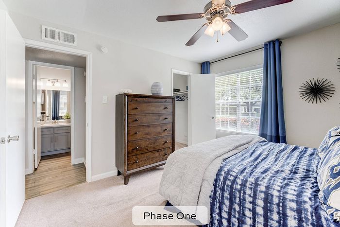 spacious bedroom with carpeting and ceiling fan