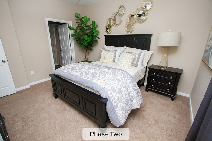 spacious bedroom with plush carpeting