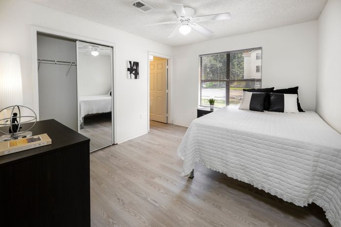 spacious bedroom with mirrored closet doors