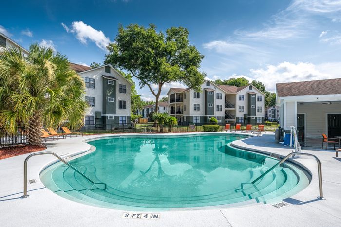 resort style pool with lounge seating beside the clubhouse