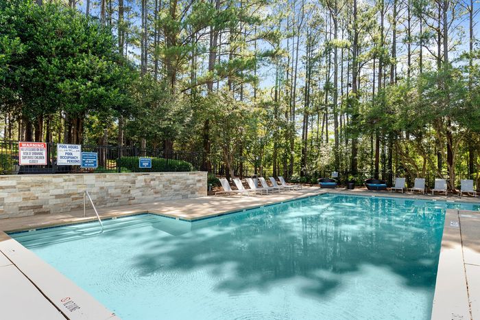 resort style pool with lounge seating and sundeck