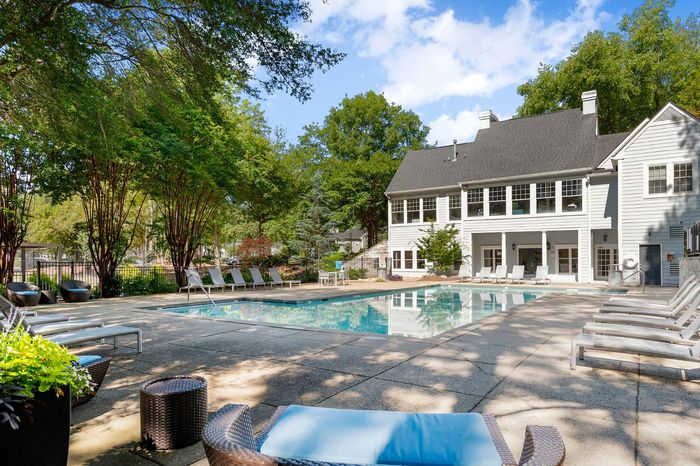 resort style pool with lounge seating and sundeck beside the clubhouse