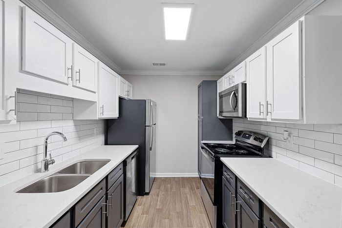 Large kitchen with stainless steel appliances, tile backsplash