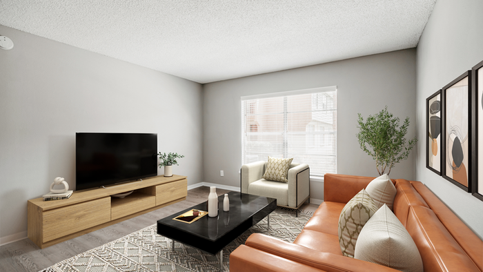 Wood floor, rug, orange leather sofa, white chair, wooden entertainment center and TV