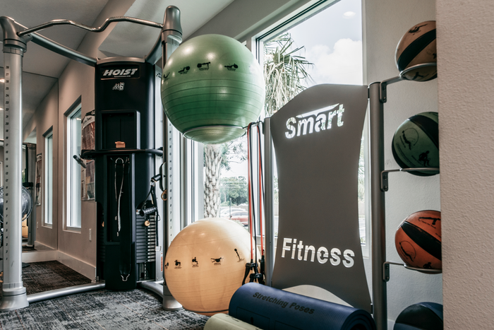 Fitness Center with exercise machines, stability balls, resistance bands, and fitness mats