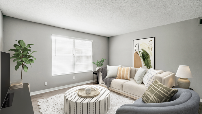 Livingroom tan couch, hardwood floors, rug, gray chair, open window